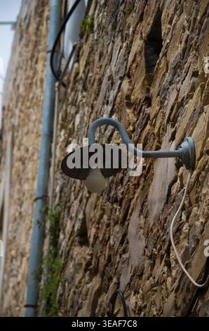 Vintage Outdoor Wall Lamp on Rustic Stone Wall Stock Photo