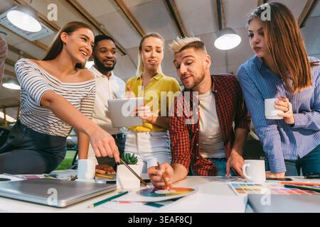 Group of Professionals Collaborating on a Creative Project in a Modern Workspace Stock Photo