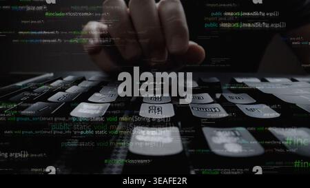 A close-up image showcasing hands typing on a keyboard with streams of digital code in a dark background, symbolizing technology, programming, and inn Stock Photo