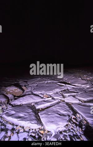 Winter Night Broken Ice Slabs and Snow on Frozen Lake Surface Stock Photo