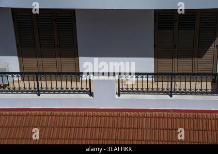 Balcony with Iron Railing and Closed Wooden Shutters Stock Photo