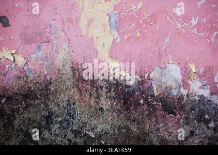 Texture of an old wall with peeling paint and mold Stock Photo