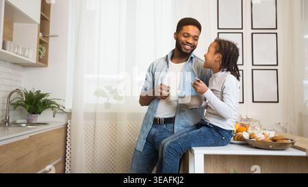 Friendly family having breakfast together in kitchen Stock Photo