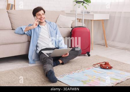 Young man preparing for vacation, consulting with agent Stock Photo