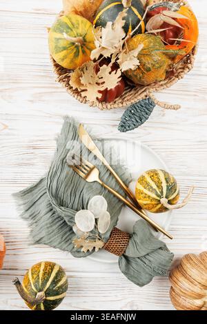 Vertical Flat Lay with Basket of Gourds and Holiday Table Setting Stock Photo