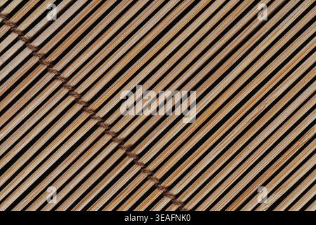Diagonal Bamboo Sushi Mat Texture on Dark Blue Background Stock Photo