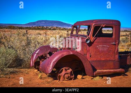 Rusty Abandoned Truck and Mount Trumbull in Sunlit Arizona Desert Landscape Stock Photo