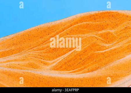 Detailed abstract texture layered orange and white sand, creating organic wavy patterns and marble effects Stock Photo