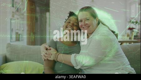 Smiling woman in blouse hugging child in green T-shirt on sofa in living room, bracelet, overlay Stock Photo