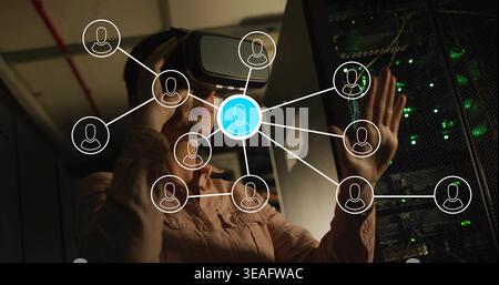 Reaching woman wearing VR headset, light shirt touching server rack in tech room, with network map Stock Photo