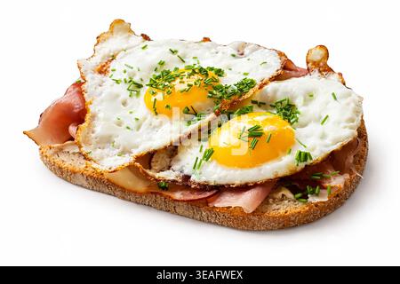 Two fried eggs with ham on toasted sourdough bread.  ****Original image by contributor, digitally enhanced using AI tools*** Stock Photo