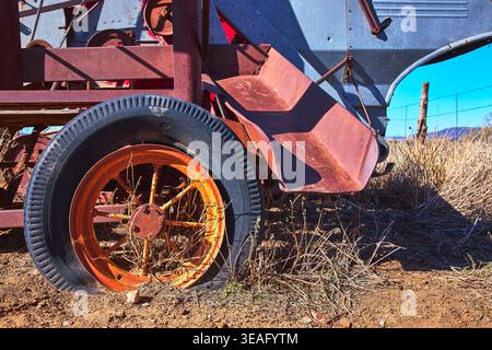 Vintage Rusted Farm Equipment Wheel and Weathered Metal Detail Close Up Stock Photo