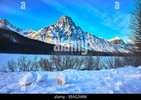 Snowy Mountain Landscape with Frozen Lake and Winter Forest in Banff Stock Photo