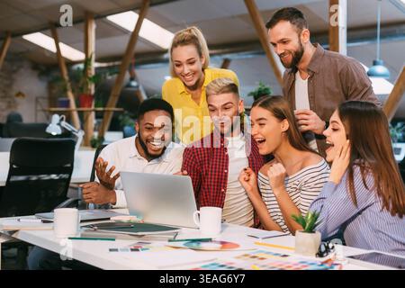 Lucky corporate team. Designers celebrate successful project Stock Photo