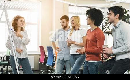 Group of Colleagues Engaging in a Brainstorming Session in a Modern Office Space Stock Photo
