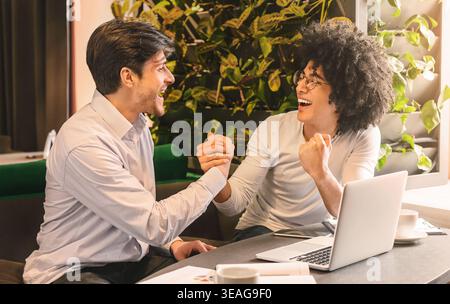 Excited partners celebrating success of their small business project Stock Photo