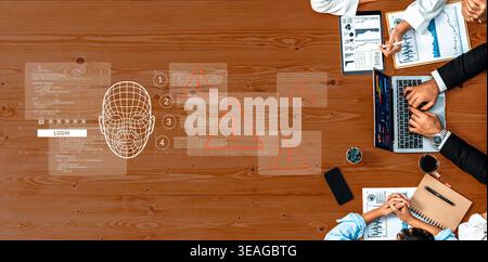 A high-angle view of a technology meeting showcasing teamwork around a wooden table, focusing on facial recognition, data analytics, and innovative id Stock Photo