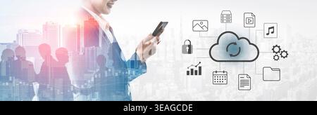 A businessman is holding a smartphone while interacting with cloud technology icons, symbolizing digital transformation in business and enhanced data Stock Photo