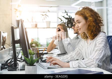 Young busy staff of employees working on computers Stock Photo
