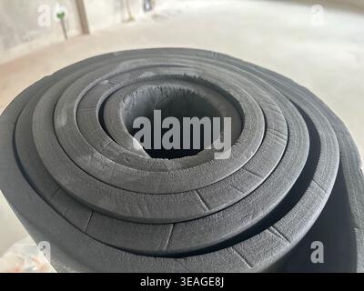 Roll of rubber foam insulation indoors, closeup Stock Photo