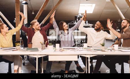 Teamwork concept. Colleagues giving high fives to each other Stock Photo