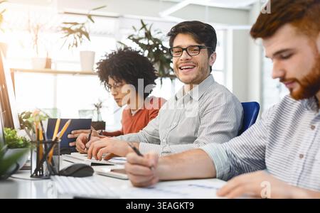 Team Members Collaborate in a Bright Office Environment While Working on Projects Stock Photo