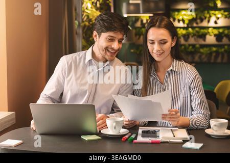 Millennial coworkers having business lunch at cafe Stock Photo
