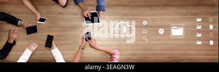 Collaborative Technology Workspace with Hands Holding Tablets and Smartphones on Wooden Table Representing Cloud Computing and Data Management Concept Stock Photo