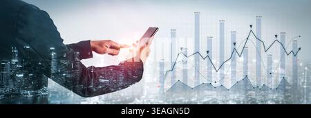 A business professional uses a smartphone for data analysis against a city skyline. This image captures modern finance, analytics, and technology in a Stock Photo
