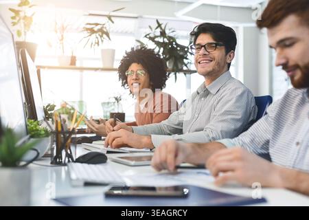 Young male team working at IT developing company Stock Photo