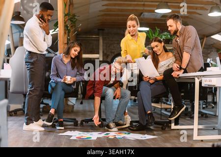 Group of Young Professionals Collaborating on Design Project in Modern Office Space Stock Photo