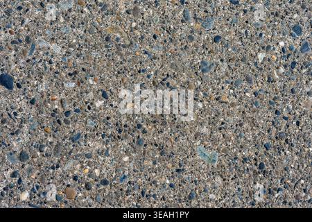 Full Frame Exposed Aggregate Concrete Texture: Dark Gray Ground Surface with Colorful Pebbles Stock Photo