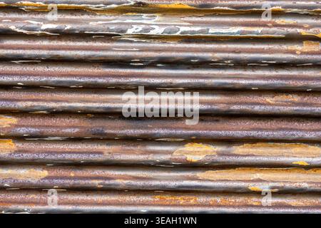 Full Frame Background of Rusted Corrugated Metal Siding with Peeling Brown and White Paint Stock Photo