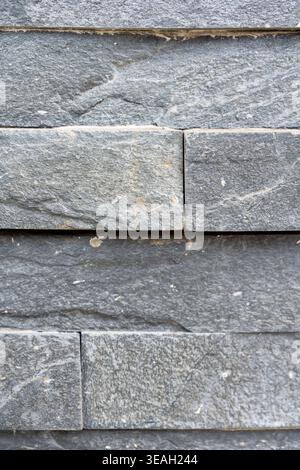 Close-up Background of Horizontal Natural Stone Bricks or Tiles with Mortar Joints Stock Photo