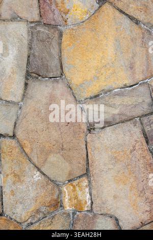 Architectural Background: Natural Stone Cladding Surface with Uneven Edges and Cement Grout Stock Photo