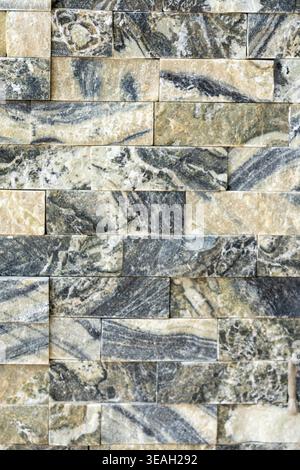 Close-up of Natural Stone Bricks with Swirling Marbled Pattern for Interior Cladding Stock Photo