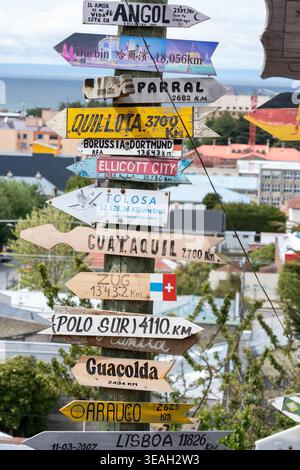 Weathered Wooden Arrows Clustered on a Post, Symbolizing Crossroads and World Travel Stock Photo