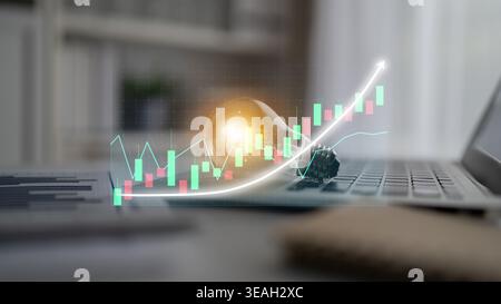 Focus on growth and innovation in business shown through a light bulb and an upward financial chart on a laptop in a contemporary workspace setting. I Stock Photo
