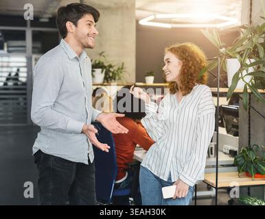 Engaged Conversation Between Colleagues in a Modern Office Environment Stock Photo