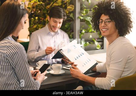 Young business team in cafe, having coffee break Stock Photo