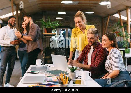 Team Members Collaborating and Enjoying Moments at a Modern Workspace During the Day Stock Photo