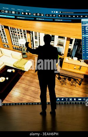 Planning home renovation project, 3D modeling software and interior decorator. Moving furniture, interactive digital interface and designer using VR controller to try out decoration styles Stock Photo