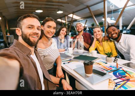 Happy designers making selfie at workplace, working on project Stock Photo