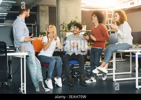 Team Members Sharing Ideas in a Modern Office Environment During a Collaborative Meeting Stock Photo
