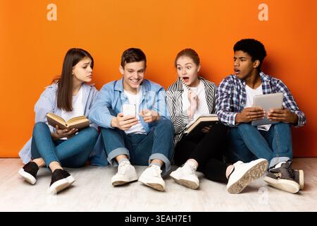 Group of Friends Engaged in Lively Discussion While Sitting on the Floor With Creative Backdrop Stock Photo