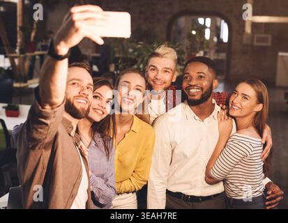 Happy business colleagues taking selfie, having break Stock Photo