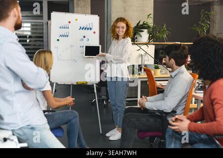 Team Collaborating During a Business Presentation in a Modern Office Setting Stock Photo
