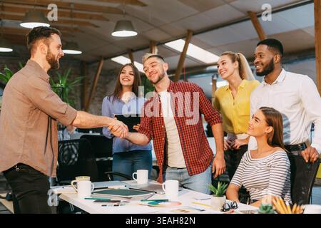 Business Team Celebrating a Successful Project Meeting in a Modern Office Space During the Afternoon Stock Photo