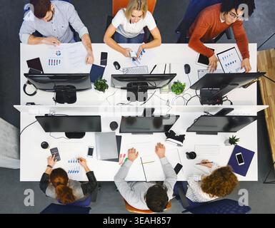 Team Collaborates on Project in Modern Office During Working Hours Stock Photo