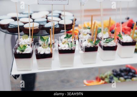 Layered Dessert Cups With Spoons Arranged, Individual Portions Of Mousse And Fruit With Chocolate And Berry Accents, Clear Cups With Metal Spoons Stock Photo